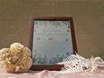Load image into Gallery viewer, Framed Quinceanera invitation with floral decorations on a textured surface